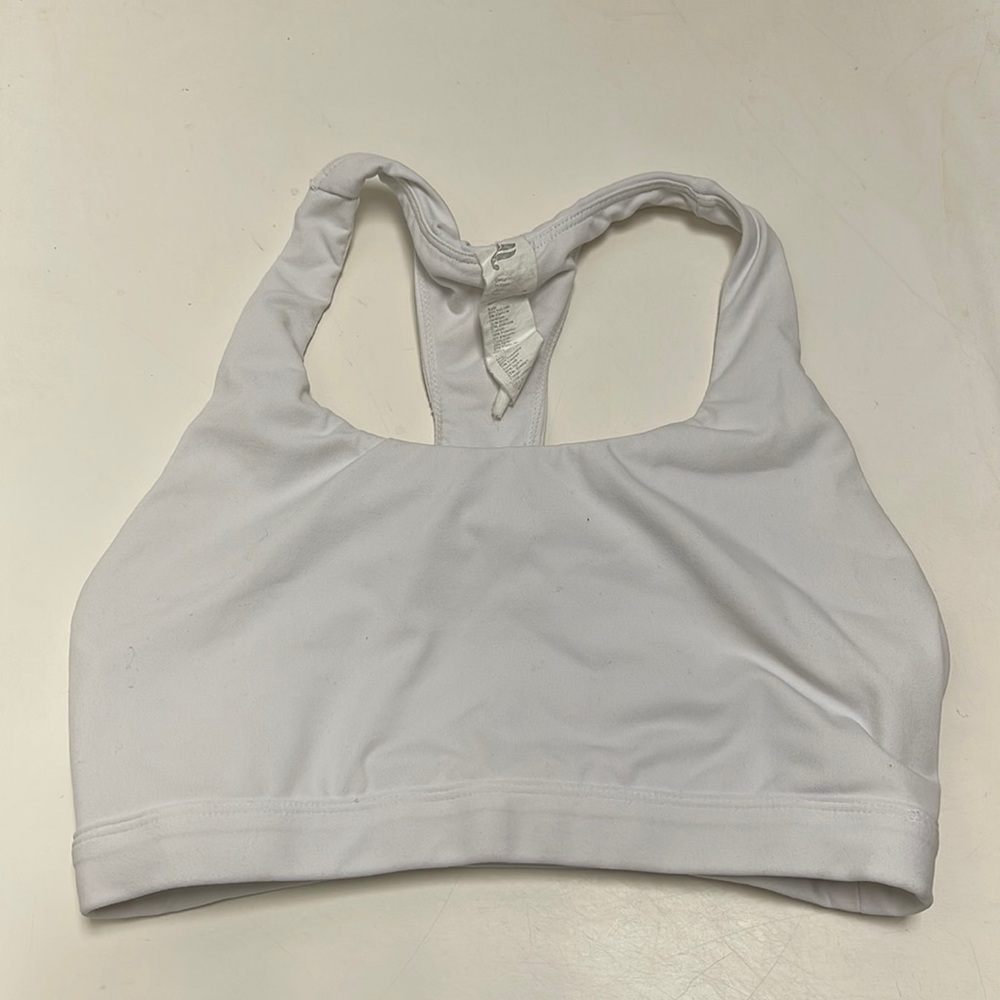 A7). Fabletics White and Green Sports Bra with Racerback Design